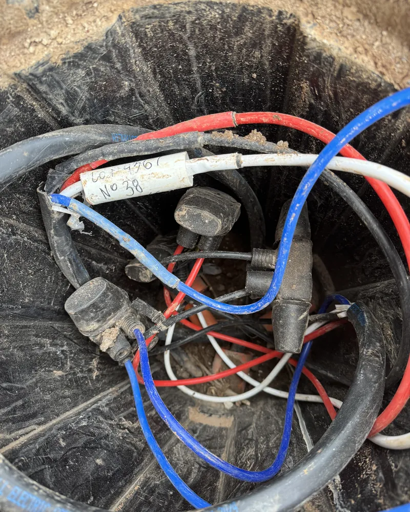 Underground consumer mains and service cables terminated in a pit