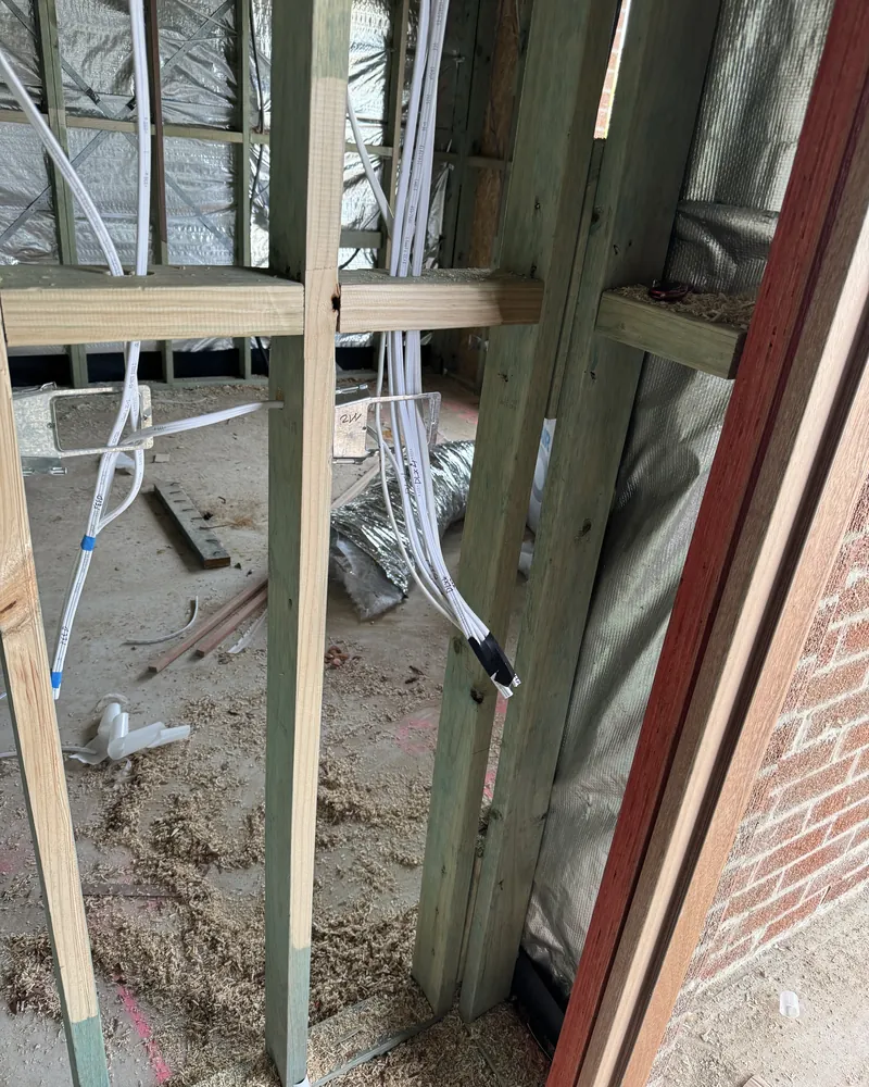 New build electrical rough in with cabling run through timber wall framing
